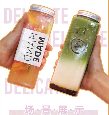 Moderne bottiglie a prova di perdite quadrate e rotonde di succo di tè al latte con manico